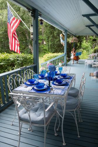 Our breakfast setting on our lovely wrap-around porch with sea view.